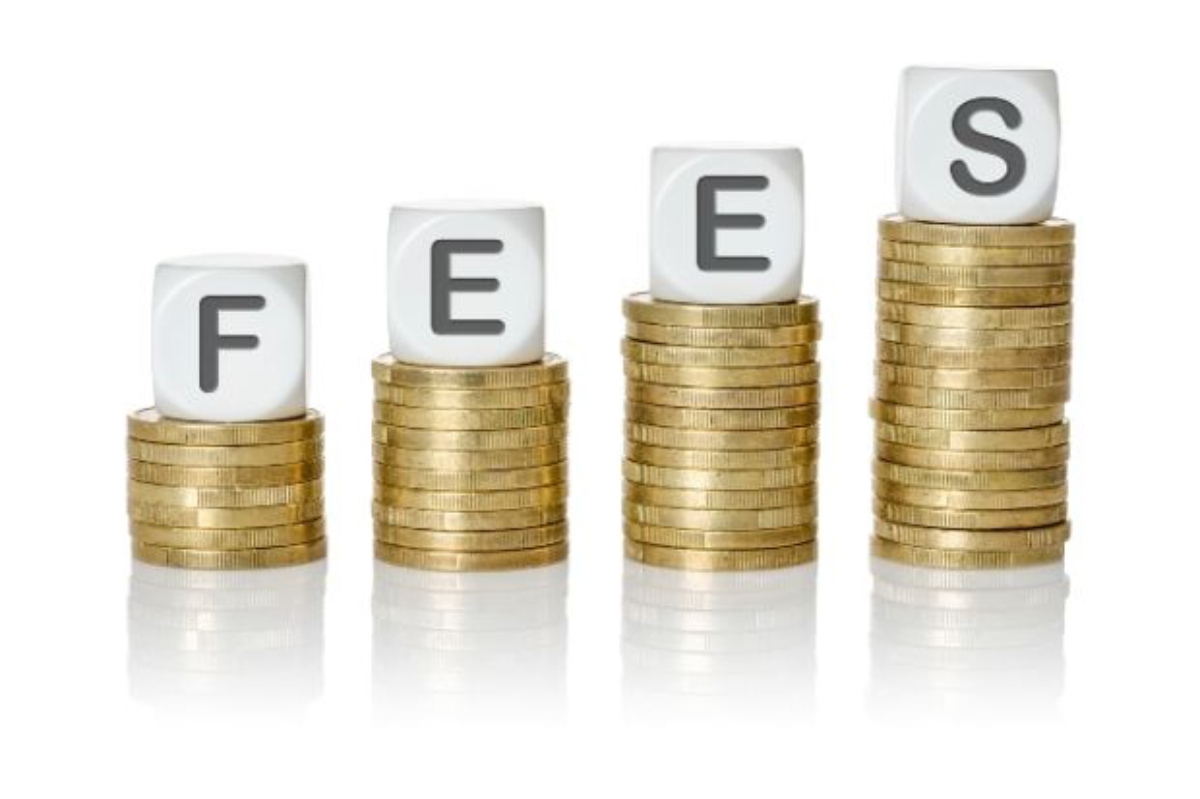 Stacks of coins with blocks spelling fees
