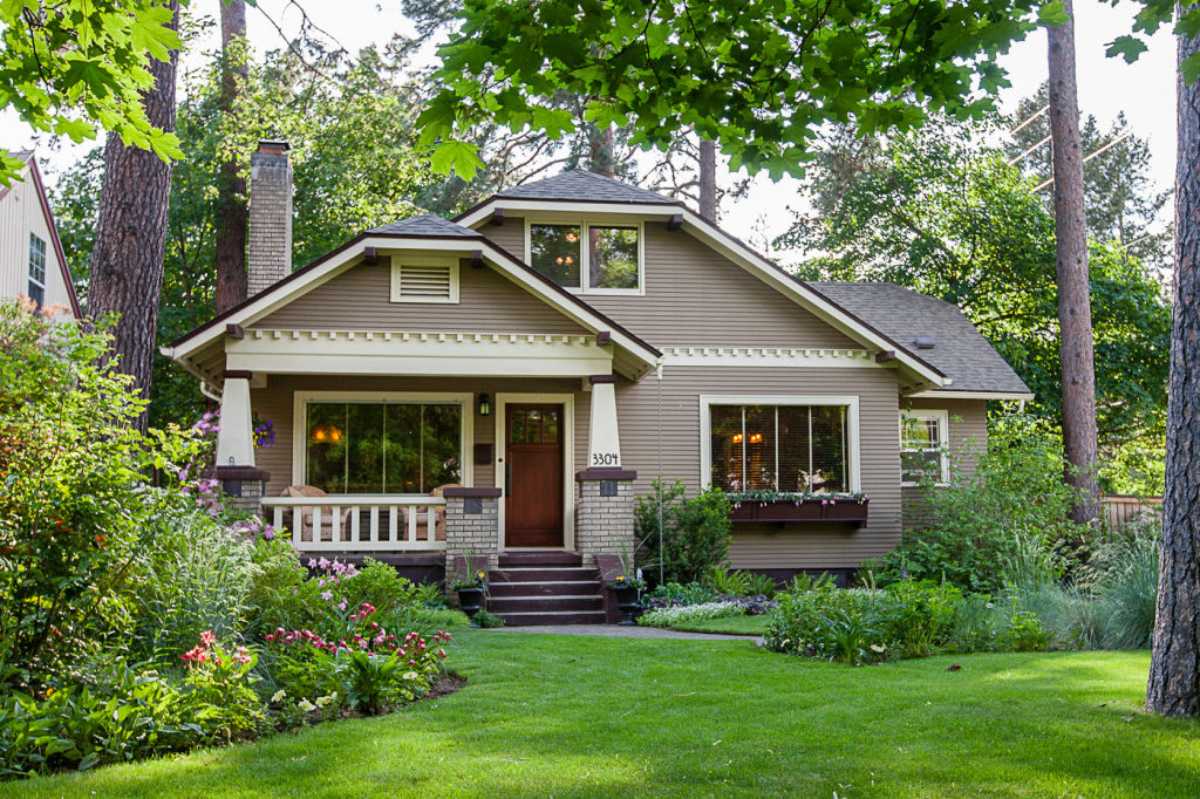 House with a front porch and landscaped yard